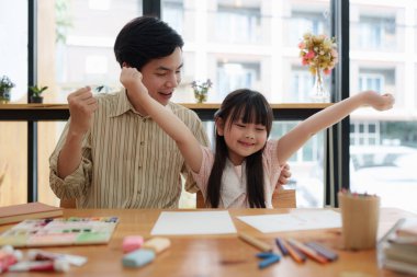 A happy kid and this father painting at home. Handmade skills training.
