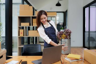 Asian SME business woman working at home office. online shopping concept.