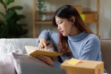 Asian SME business woman working at home office. online shopping concept.