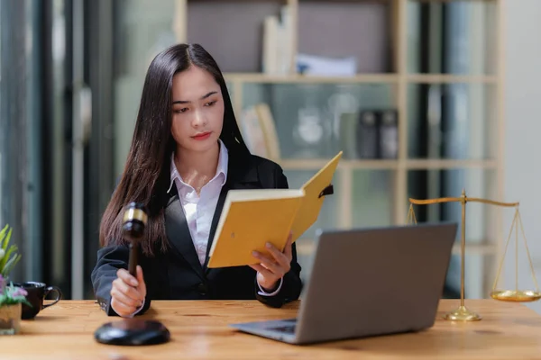 Lawyer business woman working or reading lawbook in office workplace for consultant lawyer concept.