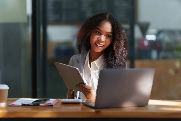 Smart black business woman using digital tablet at office space. real estate, lawyer, non-profit, marketing.