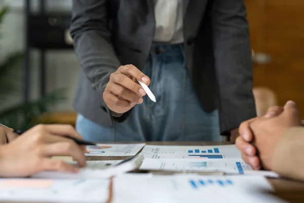 Group of business asian people analysis financial graph on desk at meeting room.