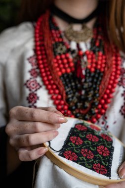 A girl embroiders a traditional Ukrainian vyshyvanka pattern