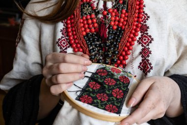 A girl embroiders a traditional Ukrainian vyshyvanka pattern