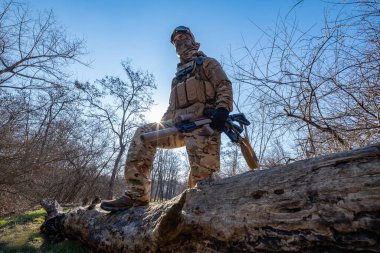 Male modern soldier in the autumn forest 