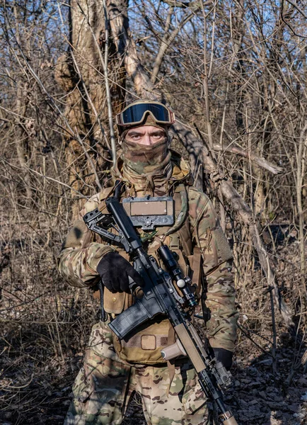 Male modern soldier in the autumn forest 