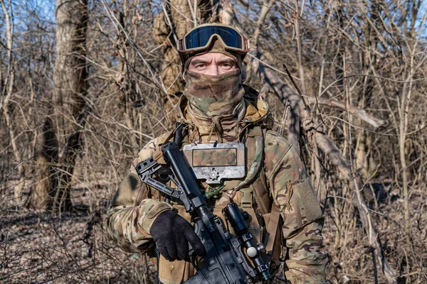 Male modern soldier in the autumn forest 
