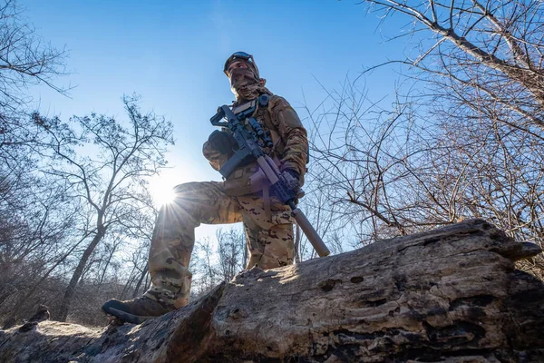 Male modern soldier in the autumn forest 