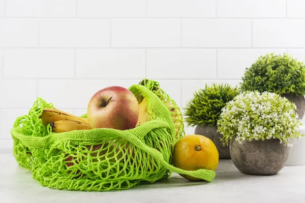 Mesh bag with fruits — Stock Photo, Image