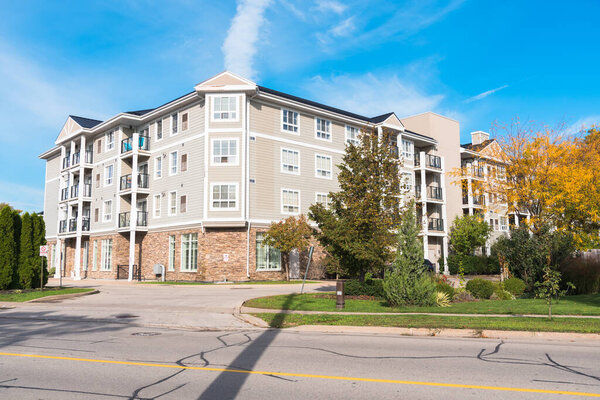 Modern apartment building along a suburban street on a sunny autumn morning