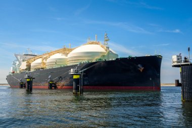Large gas tanker in a  harbour under blue sky in summer. Port of Rotterdam, the Netherlands.