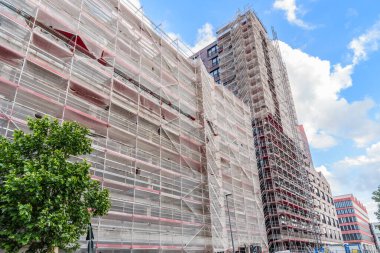 Low angle view of a high rise building in construction in a city centre on a clear summer day. Bremen, Germany.