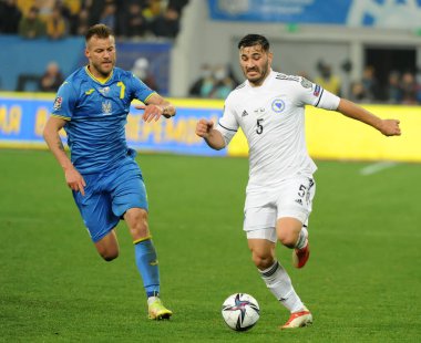 Ukraynalı Andriy Yarmolenko (7), Ukrayna 'nın Lviv kentinde oynanan Lviv Arena' da Ukrayna ile Bosna-Hersek arasındaki FIFA Dünya Kupası 2022 ön eleme Grubu D futbol karşılaşmasında Bosna-Hersek 'in Sead Kolasinac (5) takımına karşı oynadığı top için mücadele ediyor.