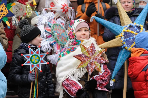Lviv, Ukraine, 8 January 2022. Children hold stars during procession of zvizdari (Christmas Star carriers) held as part of the Spalakh rizdvianoi zvizdy (The Flash of the Christmas Star) Festival in Lviv, western Ukraine. Every year, enthusiasts take