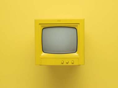 Sarı arka planda ışın tüpü olan sarı retro monitör. Retro ekipmanlar. Düz yatıyordu.