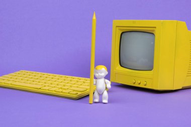 Sarı ekranın yanında sarı kalemi ve mor arka planda bilgisayarı olan bir bebek. Online eğitim kavramı.