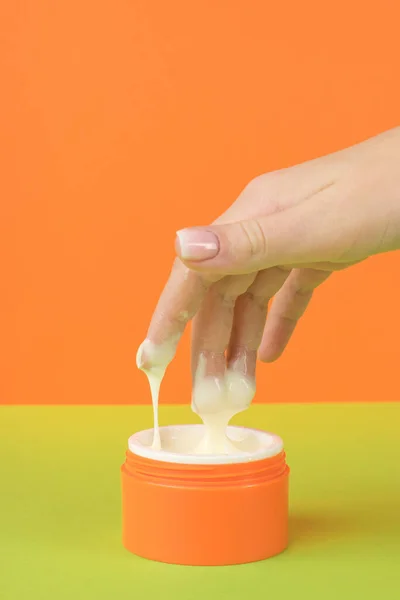 Girl Taking Cosmetic Cream Orange Jar Concept Using Cosmetics — Fotografia de Stock