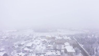 Roofs of snow-covered with fog private houses aerial view