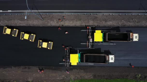 Lviv, Ukraine - April, 2021:Road construction workers with paving machine aerial top view — 비디오