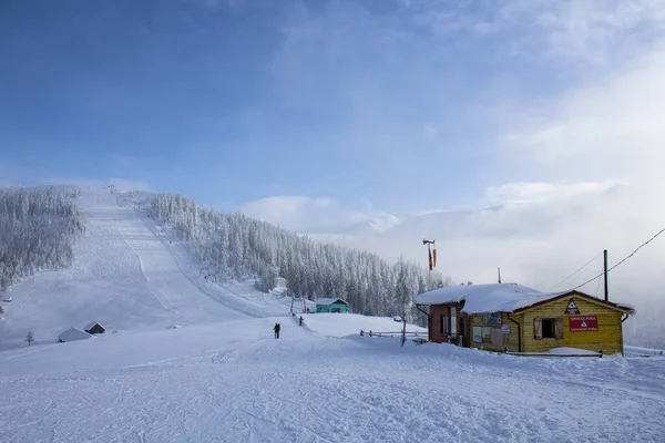 Beautiful snowy landscape of a rescue house on sky slope