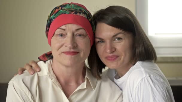 Junge Frau umarmt ihre kranke Mutter nach Chemotherapie. Liebe, Fürsorge und Unterstützung in der Familie eines Krebspatienten. — Stockvideo