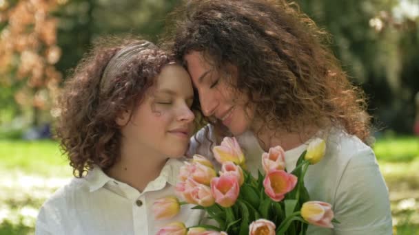 Portrait of a mother and daughter of a teenager looking at each other with love and tenderness. Mothers Day. — Stock Video