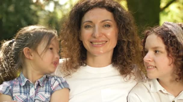 有两个不同年龄的女儿的快乐女人。在一个温泉公园的背景下。母亲节. — 图库视频影像