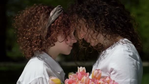 Portrait of a mother and daughter of a teenager looking at each other with love and tenderness. Mothers Day. — Stock Video