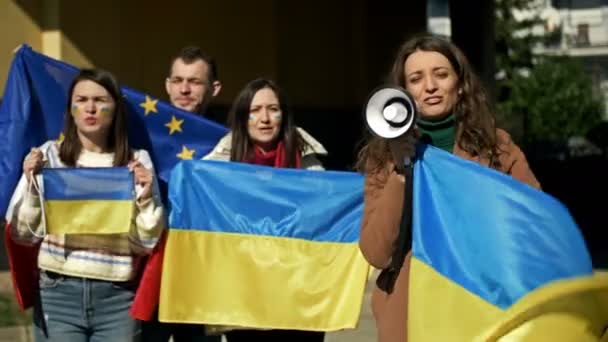 Протест против войны на Украине и российского вторжения. Люди с флагами на демонстрации в поддержку Украины. — стоковое видео