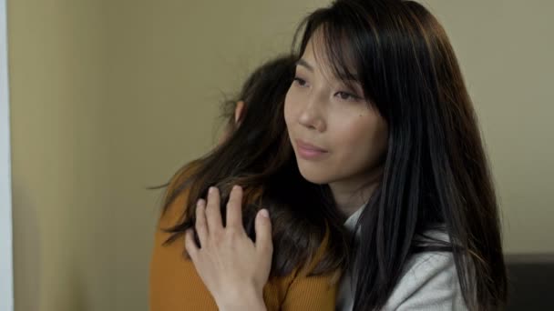 Asian mother gently hugs her little daughter. Mothers Day. — Stock Video