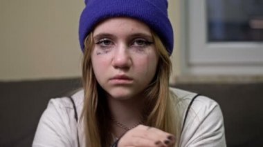 Frightened crying teenage girl asks for help. A gesture denoting a persons need for help.