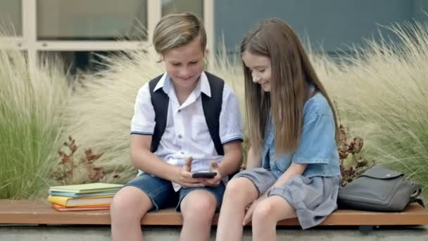 Two Friends Boy Girl Aged Sitting Bench Schoolyard Children Look — Stockvideo