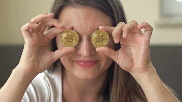 Cheerful Woman Playfully Covers Her Eyes Gold Coins Bitcoins — Stock video