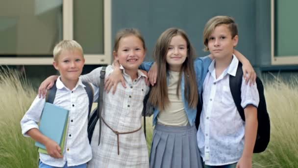 Four Friends Elementary School Students Stand Embrace Schoolyard Classmates School — Videoclip de stoc