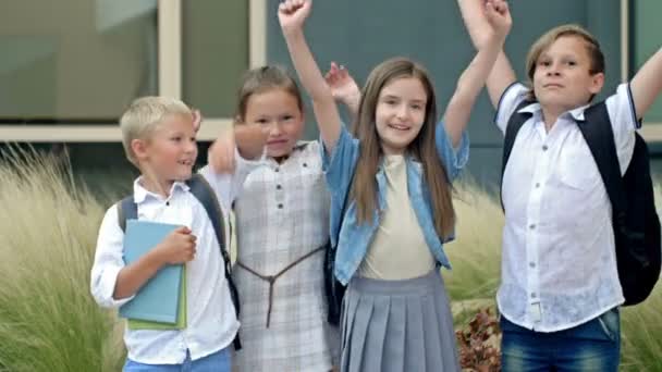 Four Friends Elementary School Students Stand Embrace Schoolyard Classmates School — Stockvideo