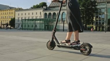 Woman on an electric scooter. 4K.