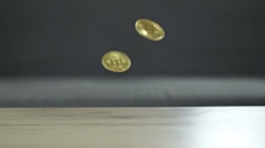 Coins falling from top to bottom as a sign of a fall in the bitcoin rate. HD.