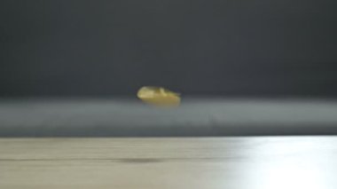 Coins falling from top to bottom as a sign of a fall in the bitcoin rate. HD.