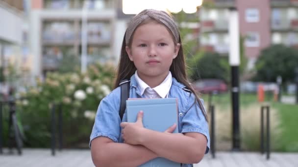 Portrait Little Schoolgirl Standing Textbooks Her Hands School Yard Back — Stock Video