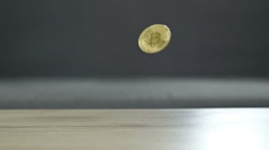 Coins falling from top to bottom as a sign of a fall in the bitcoin rate. HD.