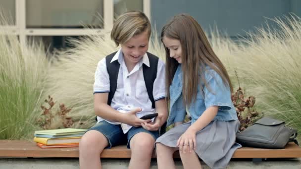 Two Friends Boy Girl Aged Sitting Bench Schoolyard Children Look — Stock Video