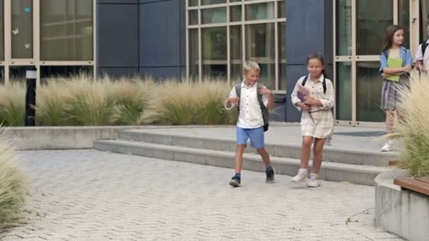 Group Elementary School Students Joyfully Run Out School Building End — стоковое видео