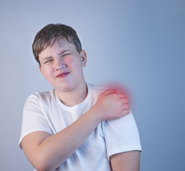 Omuz ağrısı çeken genç bir adam. Hastalık kavramı. Omzunda ağrı, kas ağrısı. Omzunda ağrı var. Hastalığın nedeni gerginlik, stres ya da yaralanma. Boşluğu Kopyala