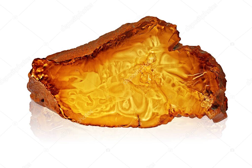 A piece of amber with a chip on white.