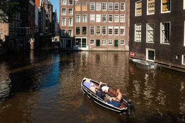 AMSTERDAM, NETHERLANDS - JUNE 13, 2021: Beautiful views of the streets, ancient buildings, people, embankments of Amsterdam  clipart