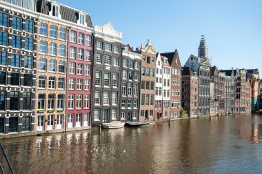 AMSTERDAM, NETHERLANDS - JUNE 13, 2021: Beautiful views of the streets, ancient buildings, people, embankments of Amsterdam  clipart