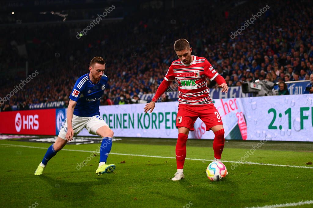 GELSENKIRCHEN,  GERMANY - OCTOBER 2, 2022: Mads Pedersen vs Rodrigo Zalazar. The football match of Bundesliga FC Schalke 04 vs FC Augsburg