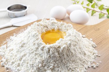 flour and eggs on wooden table