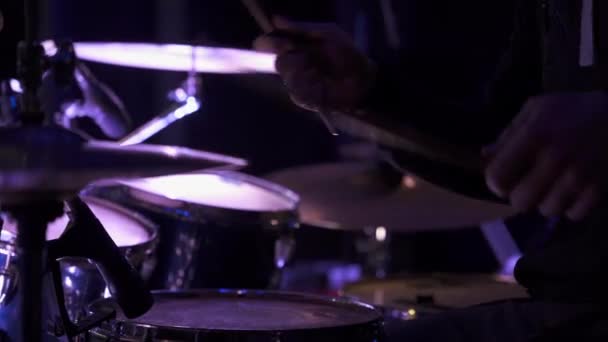 Mens hands in the frame, playing the drums on soundcheck on big concert hall stage — Stock video