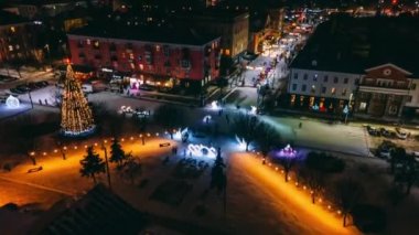 4k aerial view night timelapse hyperlapse of lighting decorations 2022 and New Year Tree in small european city